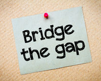 bridge-gap-message-recycled-paper-note-pinned-cork-board-concept-image-51988439